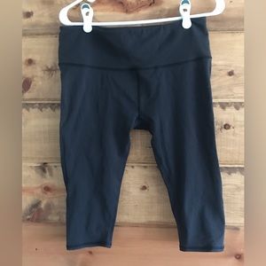 Good used condition Lululemon cropped knee leggings with net cutouts on sides.